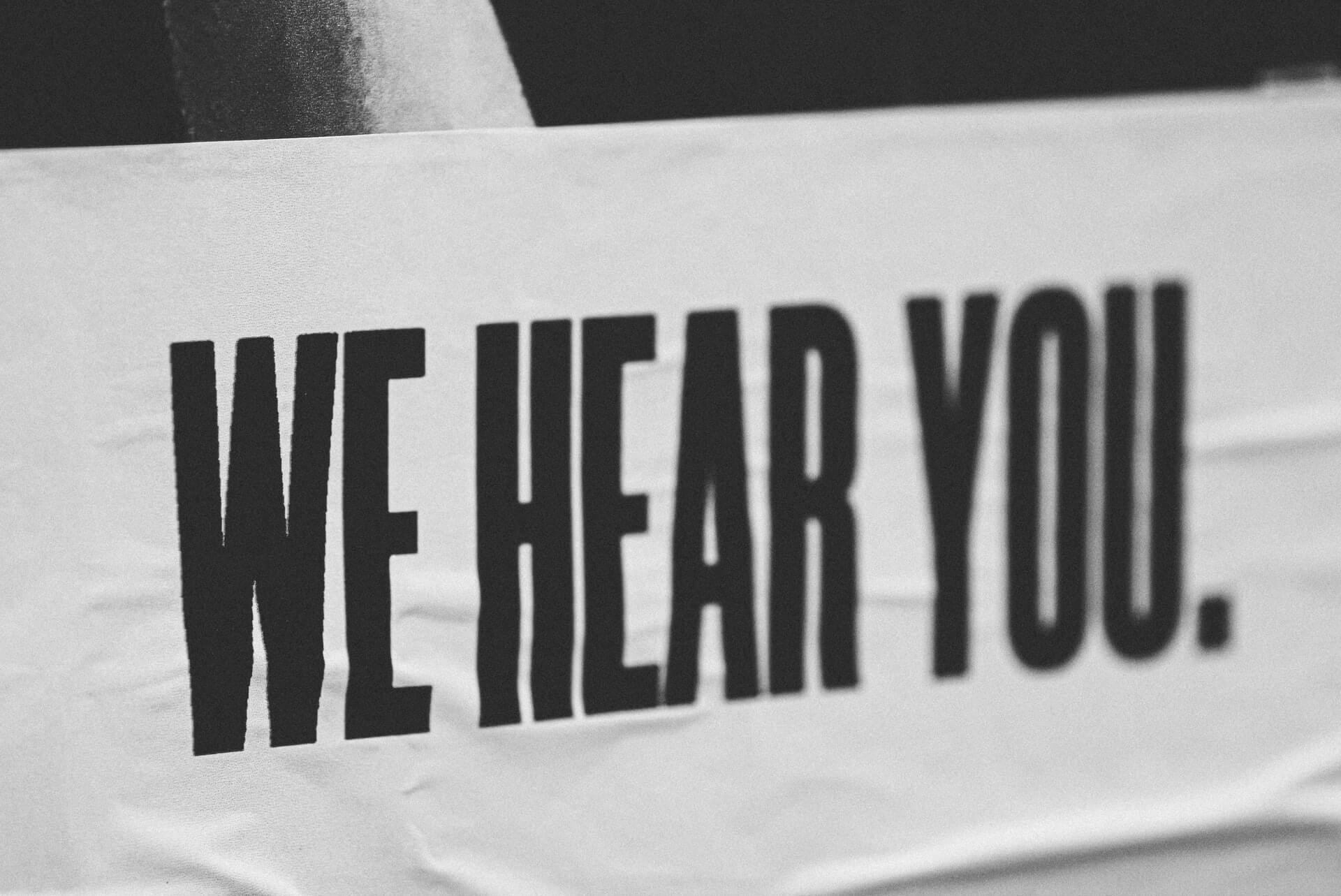 Sign saying "We hear you"