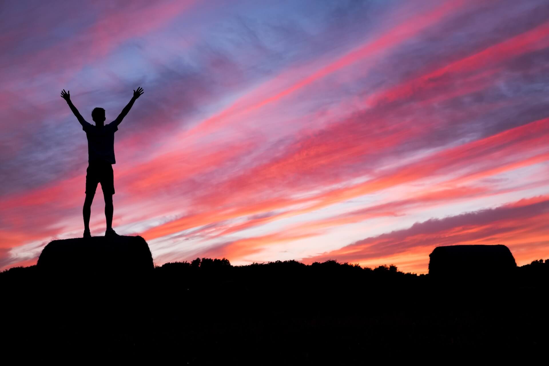 A person holding their hands up in celebration